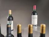 several bottles of wine are lined up in a row on a table