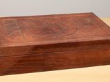 a small wooden box on a table with a lid