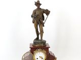 a statue of a man holding a cane and a clock