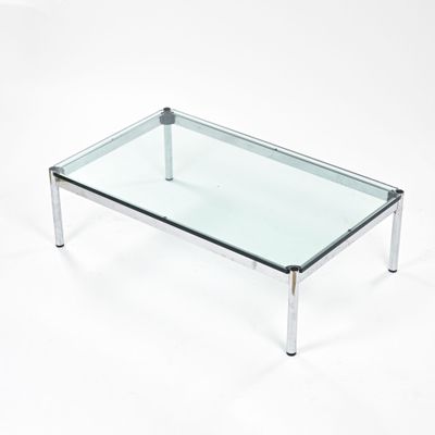 rectangular glass coffee table with chrome legs and a clear glass top