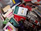 pile of books and magazines in a box on a table
