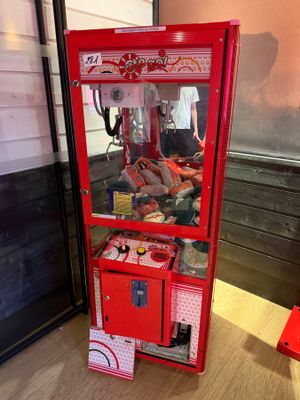 a red vending machine sitting on the floor