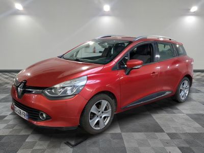 une voiture rouge garée dans un garage au sol en damier