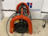 an orange blower sitting on top of a white floor next to a fahr five auction sign