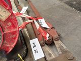 a red fire hydrant sitting on top of a table next to a pair of wrenches
