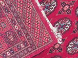 a close up of a red rug with a pattern on it