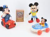 three mickey mouse figurines and a box of toys
