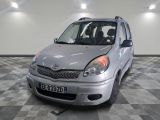 a silver car that is parked on a checkered floor