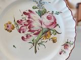 a white plate with pink flowers on it on a table