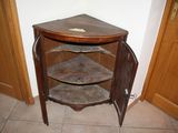 a corner cabinet in the corner of a room