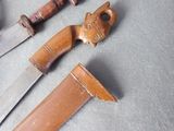 two knives that are sitting next to each other on a table
