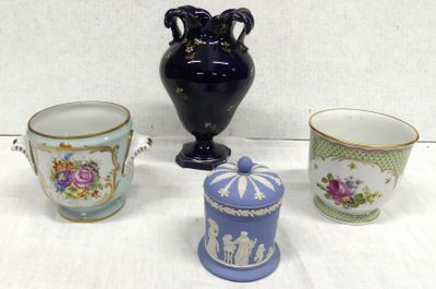 four different types of vases and cups sitting on a table
