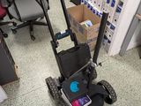 a small cart with a laptop on it in an office