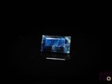a picture of a blue and white stone in the dark