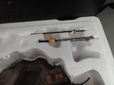 a plastic container with a knife and other items inside of it