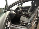 the interior of a car with the door open and the driver ' s seat down