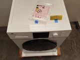 a microwave sitting on top of a white table