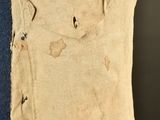 a close up of a piece of cloth with holes on it