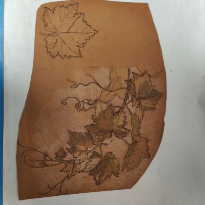 a close up of a piece of paper with a drawing of leaves on it