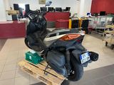 a scooter that is sitting on a pallet in a room
