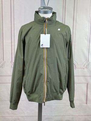 jacket on a mannequin stand in front of a white wall