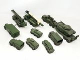 toy army vehicles are lined up on a white surface