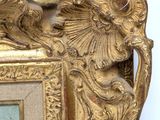 a picture of a gold frame with a bird on it