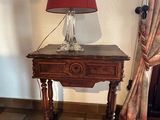 a small table with a lamp on top of it
