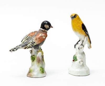 two figurines of birds sitting on top of each other