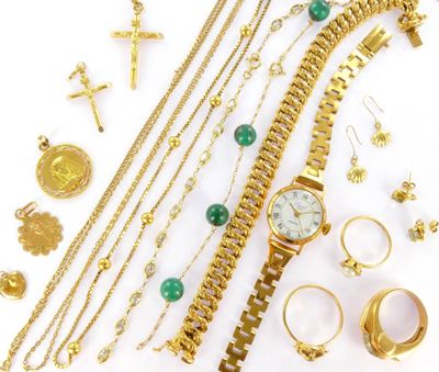 a lot of gold jewelry on a white surface