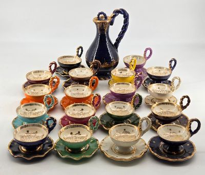 a lot of cups and saucers sitting on a table