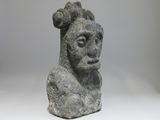 an image of a stone statue of a man with a goat ' s head