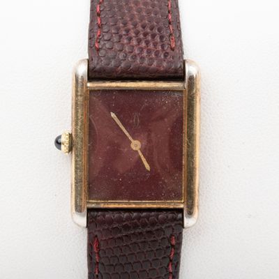 a close up of a wrist watch with a brown leather strap