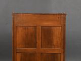 an old wooden cabinet with three doors and a drawer underneath it