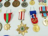 many medals and medals displayed on a white surface