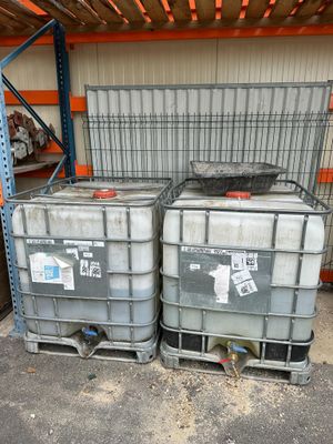 two plastic containers sitting on top of each other in a warehouse
