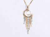 the necklace is made of gold chains and a white shell with a chain hanging from it