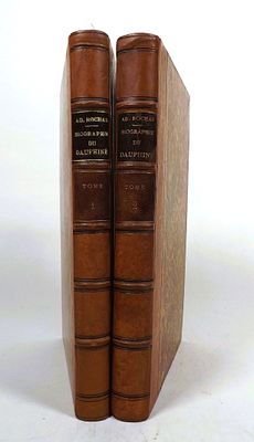 two books sitting on top of each other on a white surface