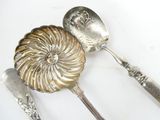 two spoons and a spoon with a shell on them