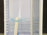 a white refrigerator with a door open in a room