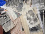 a pile of old photos and papers on a table