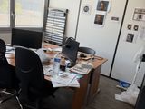 a desk with two chairs and a computer on it