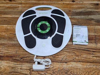 an image of a white and green robotic vacuum cleaner