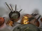 many pots and pans that are sitting on a table