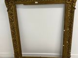 an old picture frame sitting on the floor next to a wall