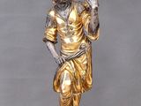 bronze statue of a man holding a flower on a pedestal