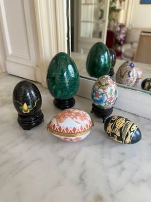 many decorative eggs sitting on a marble counter top