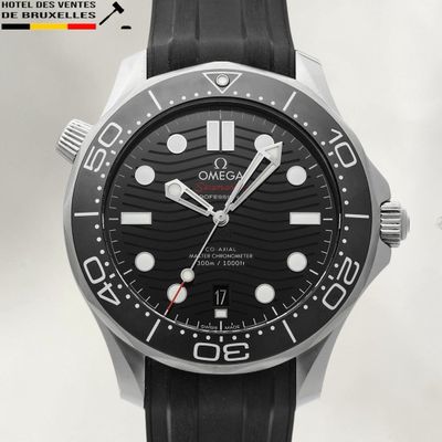 a close up of a watch with a black dial and black rubber strap
