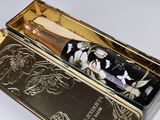 a black and gold box with a bottle of wine in it