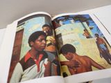 an open book with a picture of a black man in a red shirt